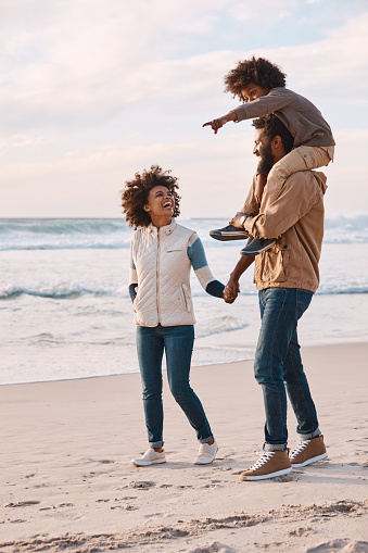 Shot of a happy young family going for a walk along the beach