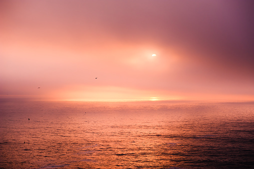 Beautiful sunset in Atlantic ocean near the coast of Algarve, Portugal. Colorful nature background