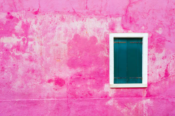 istock Window with green shutters on the shabby pink wall. 1201599976