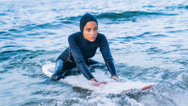 istock Female surfer with hijab in sea 1201604614