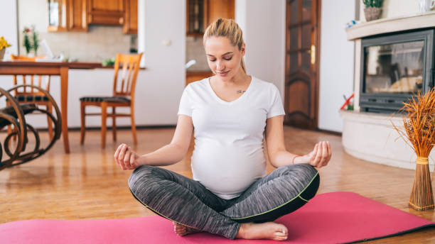 istock Pregnant woman practicing yoga at home 1201605621