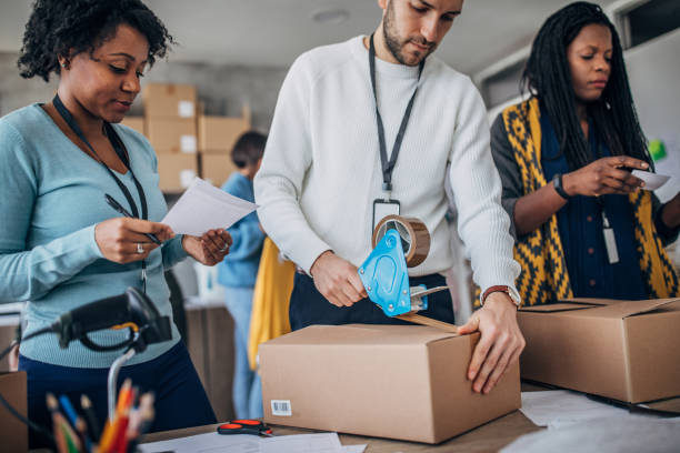 istock Diverse group of people arranging customers orders for drop shipping 1201609068