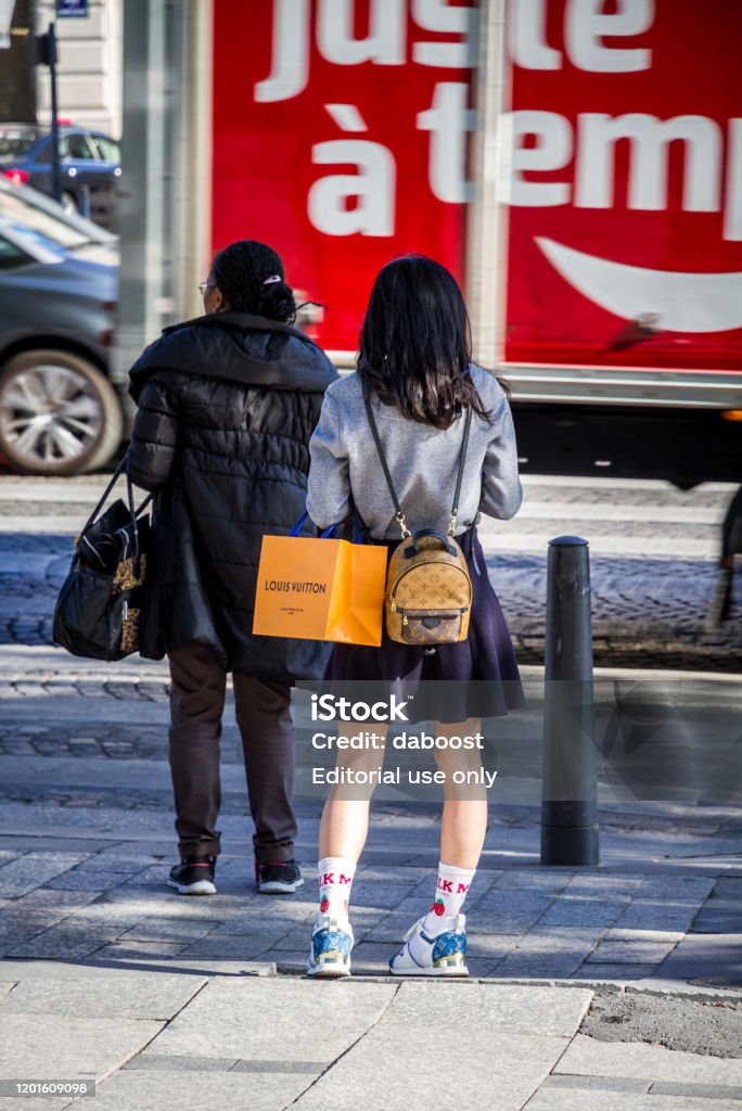 Asian Tourist Girl With A Louis Vuitton Shopping Bag On Champselysees  Avenue Stock Photo - Download Image Now - iStock