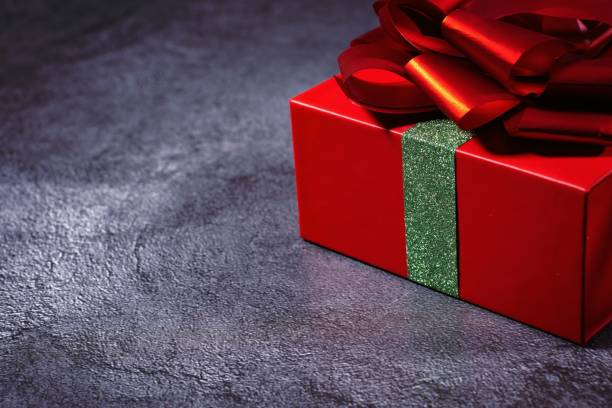 istock box with ribbon and red bow isolated on gray background 1201610541