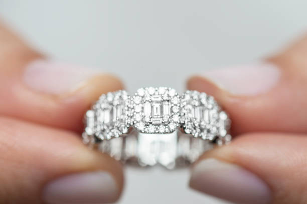 istock Woman Holding A Diamond Ring 1201611976