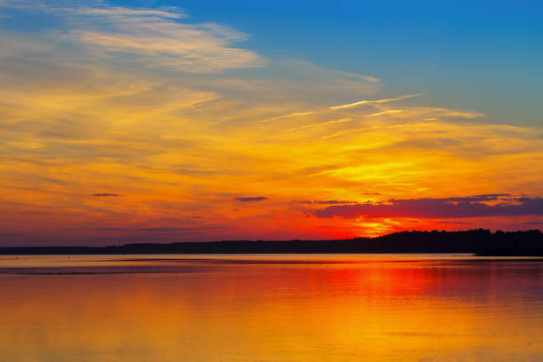 istock Beautiful sunset sky over the lake on a summer evening 1201612478