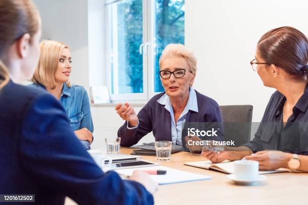 Confident Owners Discussing In Meeting At Office Stock Photo - Download Image Now - 35-39 Years, 40-44 Years, 70-79 Years