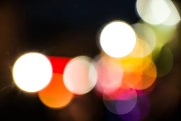 Intersection of circles of light with mixed colours and degrees of transparency. Abstract bokeh.