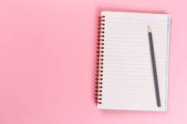 istock Sketchbook on colorful background. Copy space. top view of blank open notebook, concept of education or new workplace 1201613373