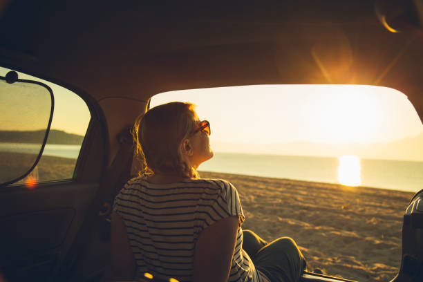 istock Watching the sunset on the beach 1201613418