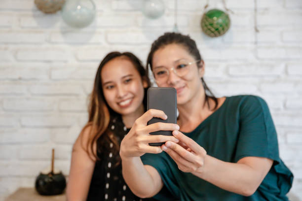 istock Happy girlfriends taking selfie pictures 1201613778