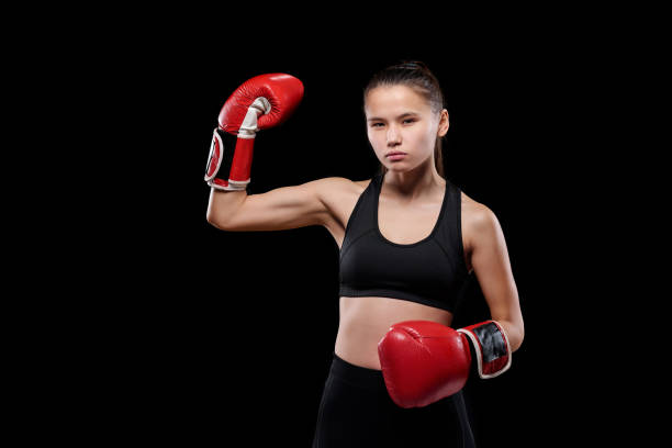 istock Young strong sportswoman showing her power before training or competition 1201613850