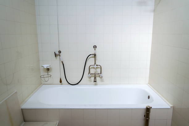 istock Beautiful shower bath with hot and cold water taps, white tile design wall, modern functionalism architecture 1201613893