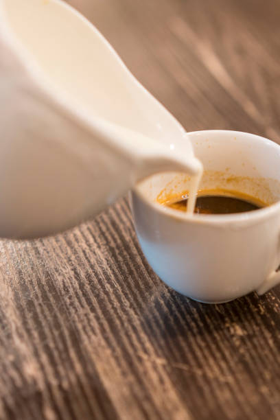 istock Cream is poured into coffee. Breakfast concept 1201613950