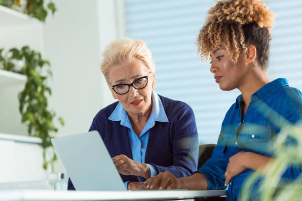 istock Serious entrepreneurs using laptop at office desk 1201614014