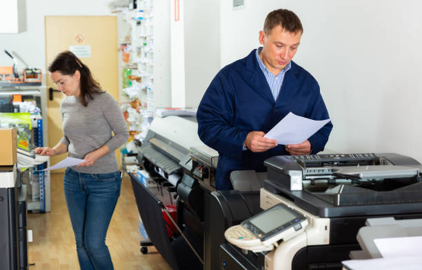 istock Printing company employees work on various printing machines 1201615124