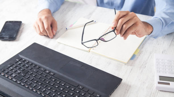 istock Man hand glasses working in office. 1201616223