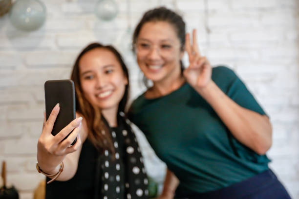 istock Happy Asian girls addicted taking selfie 1201616277