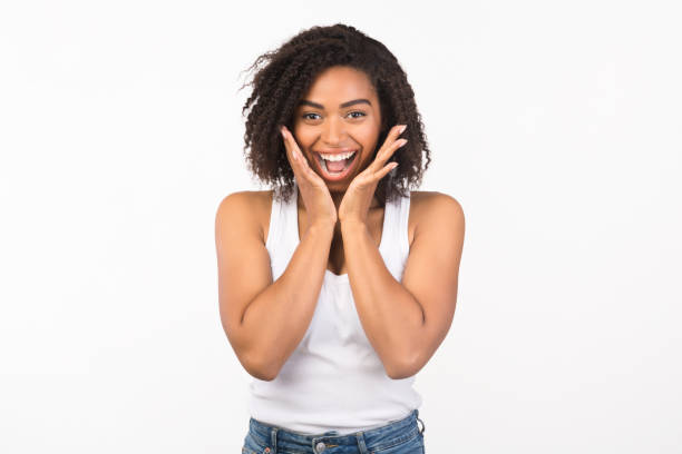 istock Happy black woman screaming and holding cheeks 1201618123