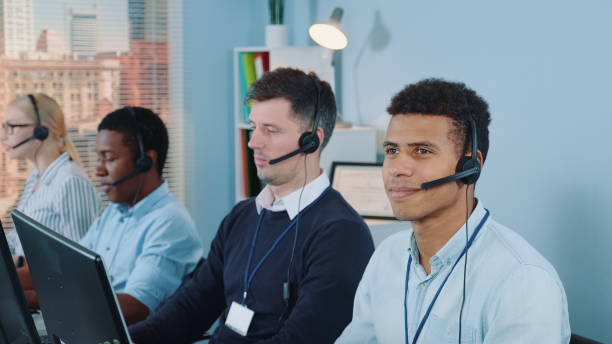 istock Cheerful customer support agent of mixed ethnicity talking on phone with a headset 1201618573