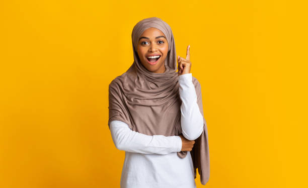 istock Young Afro Woman In Hijab Pointing Finger Up, Having Idea 1201619709