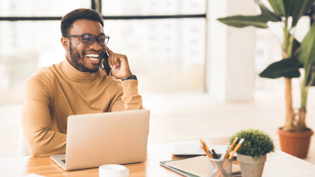 istock African american guy talking on phone at work 1201619735