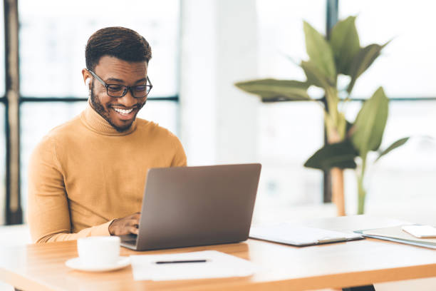 istock Smiling afro guy in glasses studying in bar 1201620839