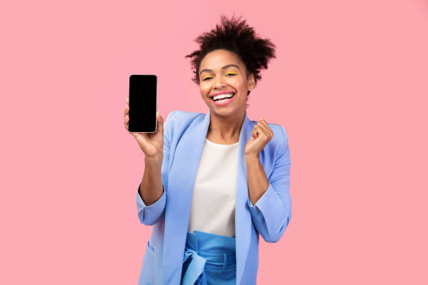 istock Afro girl showing blank black cell phone screen 1201620968
