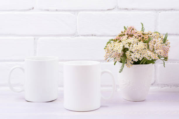 istock Two coffee mug mockup with pink beige wild flowers 1201624403