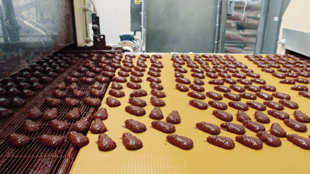 istock Candy factory. Conveyor with chocolate candies 1201624954