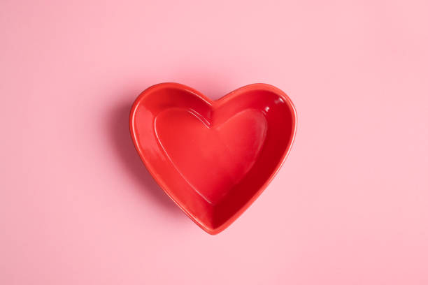 istock Close-up red heart shaped plate on pink background. Valentines day empty mockup. 1201626399