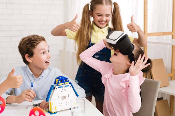 istock Excited girl using VR glasses at stem lesson 1201626441