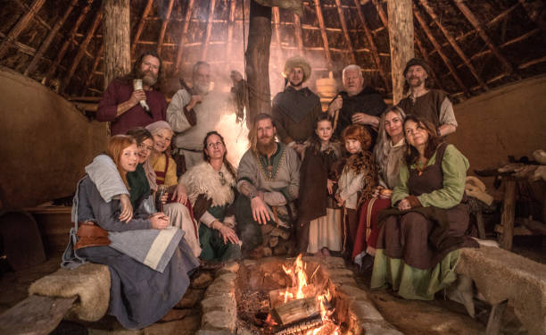 A family group of viking villagers having a fun meeting in a warm settlement hall