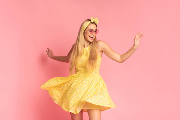 istock Cheerful woman dancing over pink studio wall 1201627266