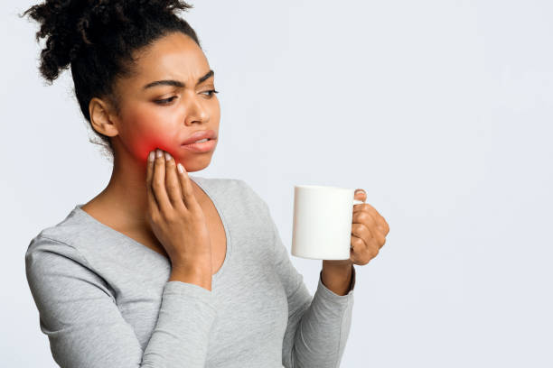 istock Black girl drinking coffee and touching her cheek 1201627386