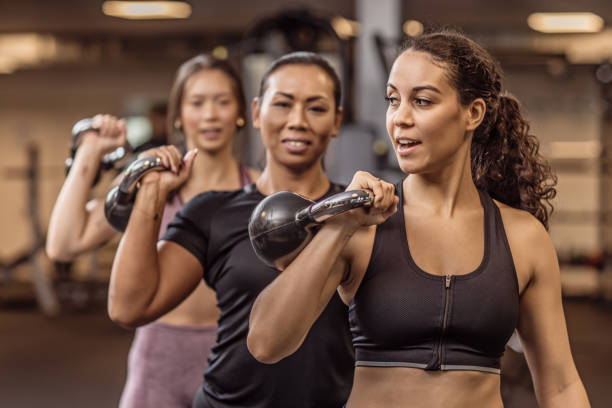 istock Three mixed race female friends in the Gym 1201628084