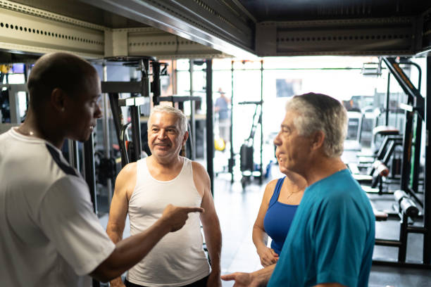 istock Friends and personal trainer talking at the gym 1201629501
