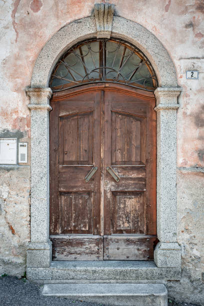 istock round-arch old wooden brown door 1201630432