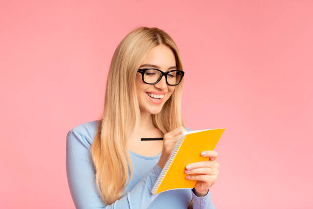 istock Teenager holding pen and notebook at studio 1201632460