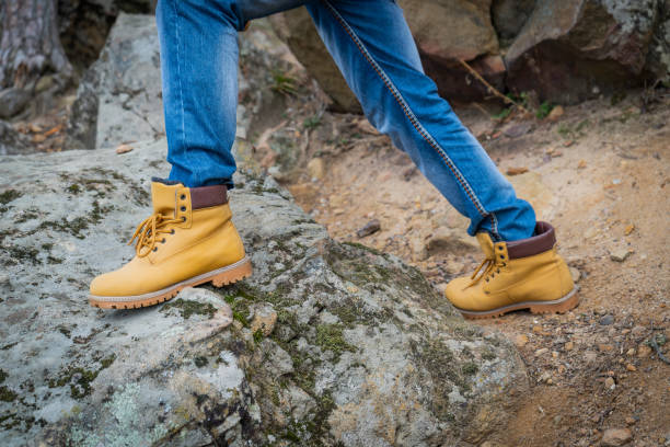 istock Pair of old yellow working boots on cliff 1201633036