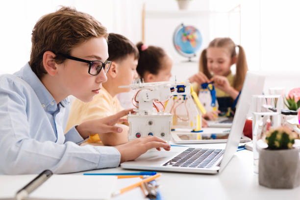 istock Creating robots. Concentrated boy typing on laptop 1201633043