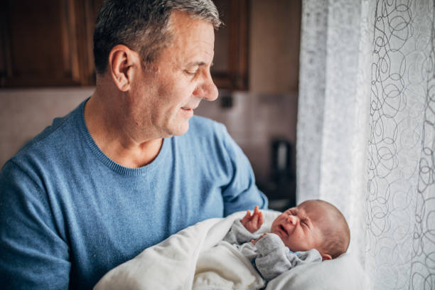 istock Grandfather holding his grandson 1201633219