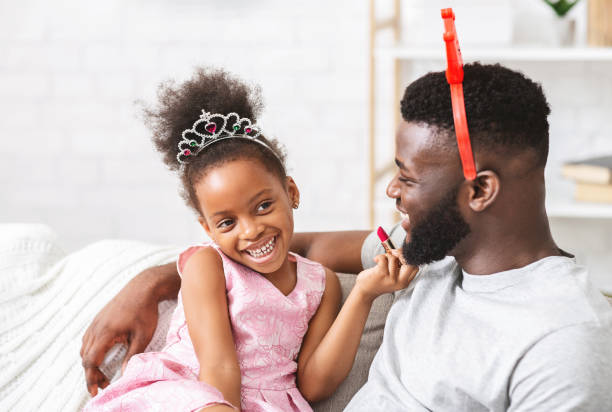 istock Little cute princess putting make up on her father 1201633786