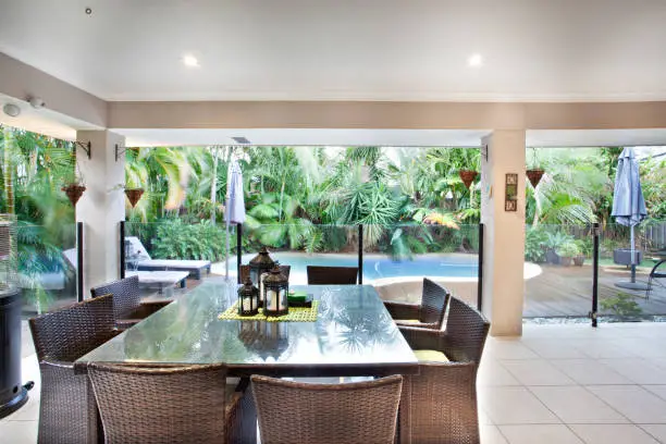 Photo of Outdoor dining glass table near swimming pool