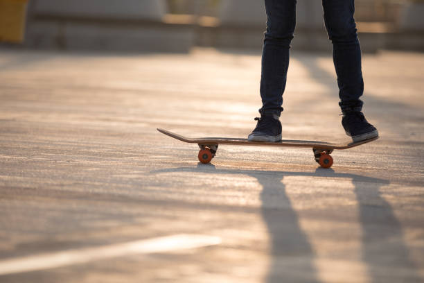 istock Skateboarder skateboarding at sunrise city 1201637177