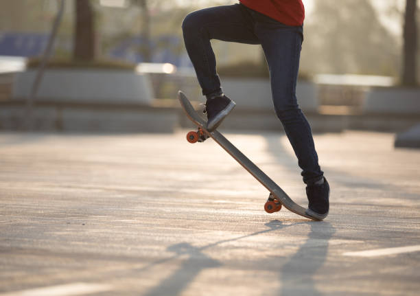 istock Skateboarder skateboarding at sunrise park 1201637195