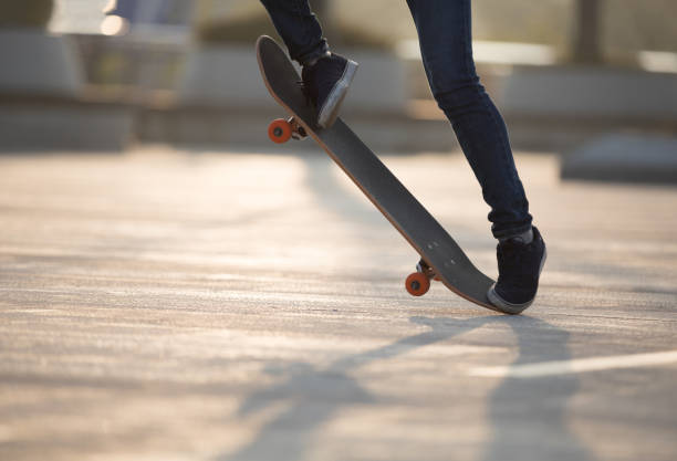 istock Skateboarder skateboarding at sunrise park 1201637400