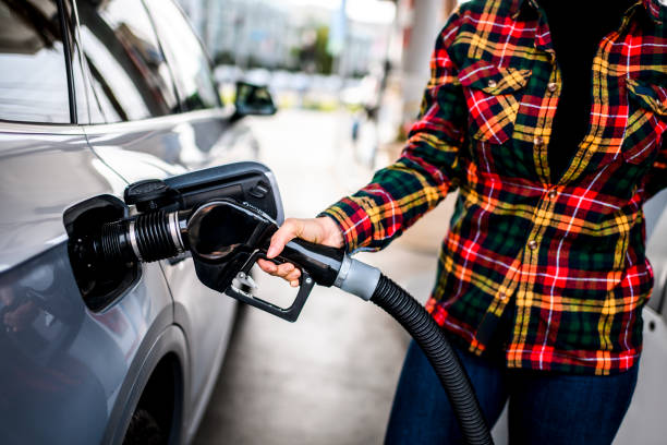 istock Filling a car with gas at a station 1201638339