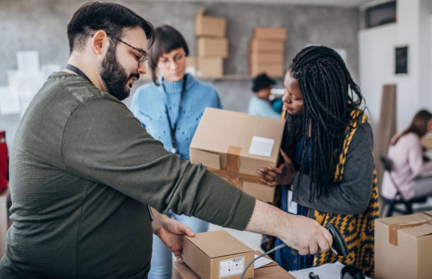 istock Diverse group of people arranging customers orders for drop shipping 1201639387