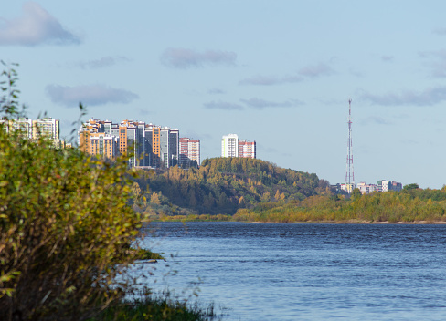 City on the river bank on a warm autumn day. Soft wind, warm colors, river, autumn, walk, horizon, TV tower, background, landscape